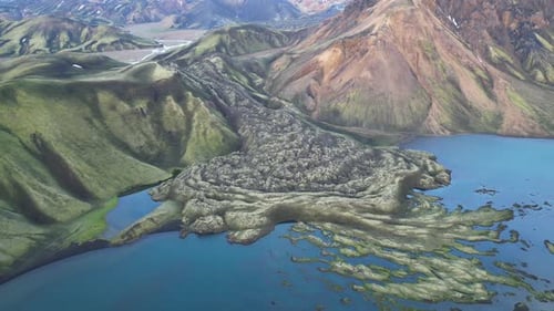 Scenic drone view of rugged mountains covered with grass and moss against the sky in Iceland
