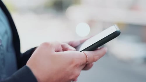 Hands, phone and texting in the city for social media, communication or online chatting