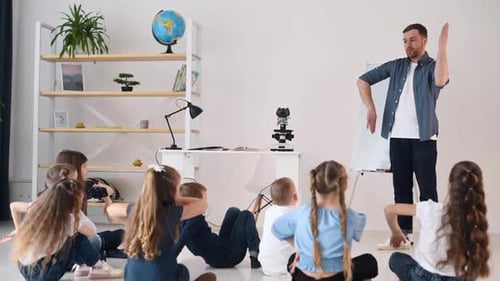 Doing gestures, learning how to spoke something. Group of children students in class at school