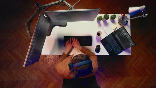 Top Down View of Developer Typing Complex Code on Laptop
