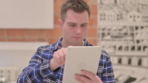 Man Using Tablet Indoors at Home