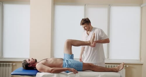 Osteopath Treating Male Patient in Clinic