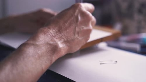 Close Up of Artist Stencilling a Wooden Sign