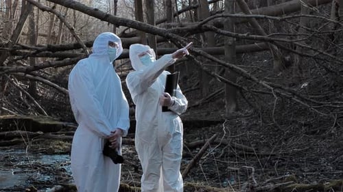 Forensic Specialist Working in the Forest Police Criminalists Collecting Evidence and Making