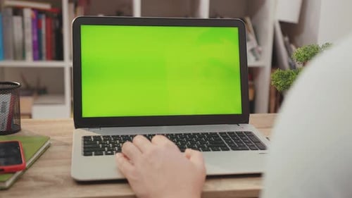 NEW YORK April 5 2019 Close Up Hands Man Use Laptop Computer with Green Screen Chroma Key Display