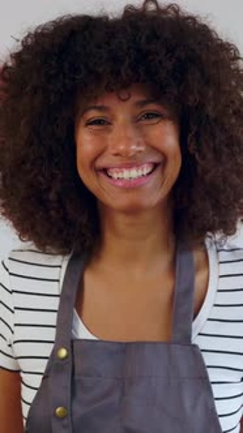 Happy Woman Smiling at Camera While Cooking Healthy Meal for Dinner at Home