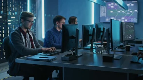 Team of Young IT Programers Working on Desktop Computers in Data Center System Control Room. Displa