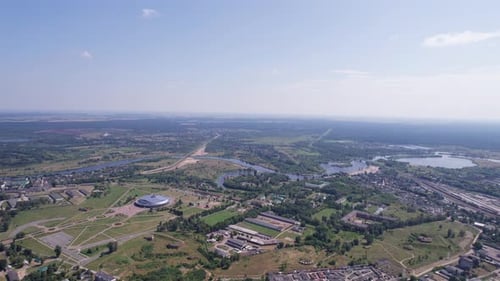 Aerial View of a Sports Arena on the Outskirts of the City and a River with a Network of Lakes on a