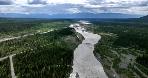 Approaching the bridge crossing the river in the wooded valley.