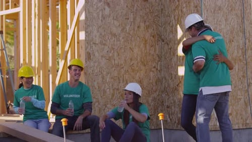 Volunteers Building a House take a Water Break