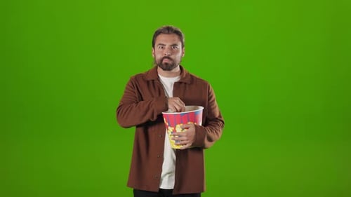 Man Eating Popcorn and Watching Interested Movie