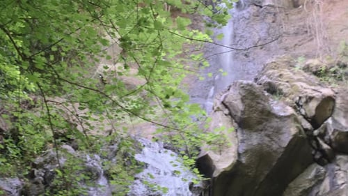 Upper Waterfall in a forest winth green trees Pan Left to Right Shot 4k 30fps