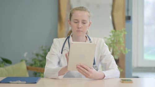 Female Doctor using Tablet in Clinic