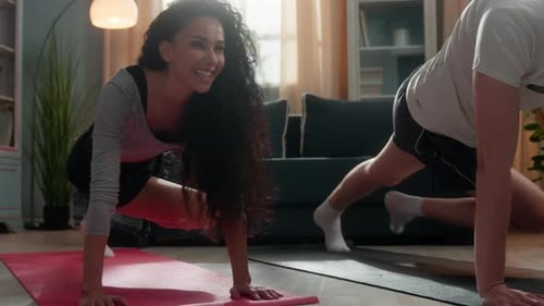 Athletic Couple Doing Mountain Climber Exercise at Home