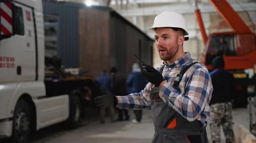 Construction Worker Directing Modular Home Loading Onto Truck