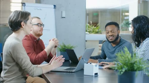 Group of Diverse Young Professionals Work on a Problem Solving in the Meeting Room. Mixed Ethnicity