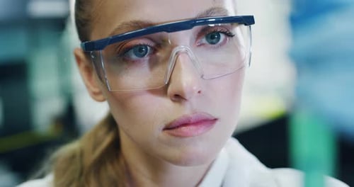 Close up of blond female scientist is analyzing a liquid to extract the DNA and molecules in the t
