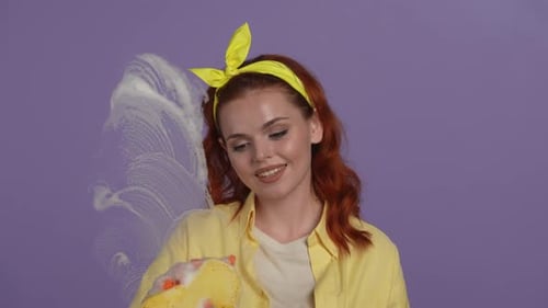 Smiling Woman Cleaning an Unseen Surface