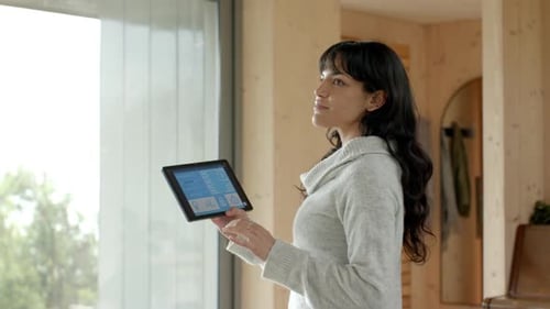 Woman Controls Smart Home with Tablet Technology