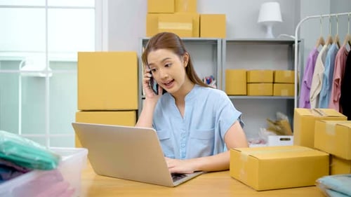 Young Adult Working With Laptop and Cellphone