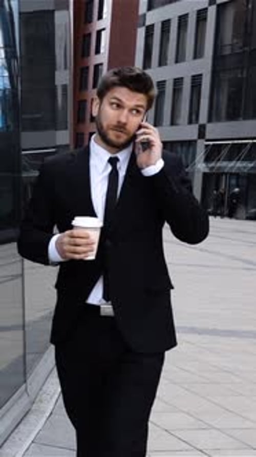 Vertical of Businessman Talking on Mobile Cell Phone in City Urban Male Professional Drinking Coffee