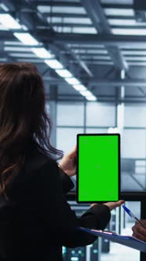 Vertical Video Workers Using Mockup Device in Server Room Checking Infrastructure Reliability