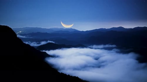 Sea of clouds at the top of the mountain. Blue sky dotted with stars..