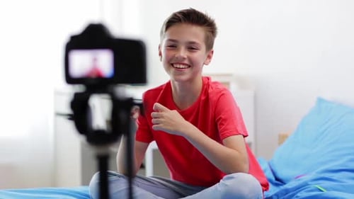 Teenager Sitting on Bed Speaking to Camera