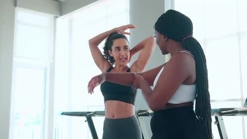 Coach or instructor training woman workout with warm up and stretch muscle arm in fitness gym.