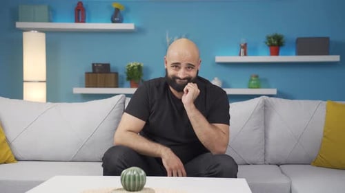 Man looking thoughtfully at camera.
