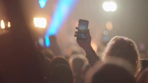 Crowd at Concert with Phone Recording Blue Lights