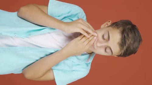 Vertical video of Sick boy coughing.