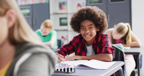 Diverse female teacher and happy schoolchildren having science class in school lab