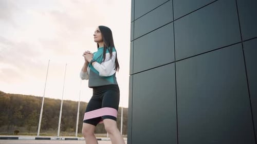 Woman Exercising with Resistance Band Outdoors