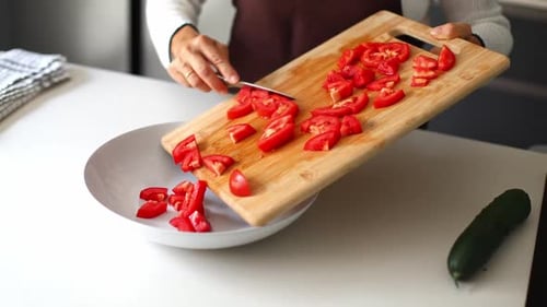 Chopped Tomatoes Being Poured Into Bowl For Salad