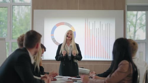 Female Expert is Giving Lecture About HR Management or Advertising in Business Meeting