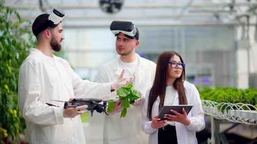 Scientists Exploring Agriculture with Technology in Greenhouse