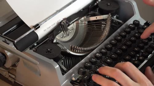Writing a book and typing old typewriter, top view. Man typing on old vintage retro typewriter