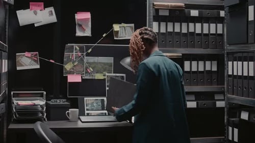 Woman Working at Desk in Dark Office