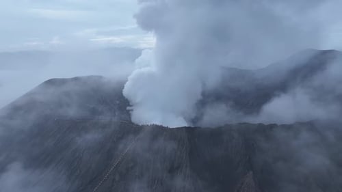 aerial view flying to mount Bromo active volcano above sea of clouds, Java, Indonesia