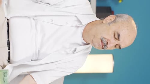 Vertical video of The old man who feels physically weak.