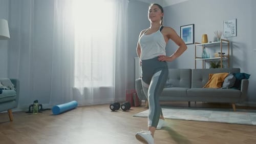Strong and Beautiful Athletic Fitness Girl in Sportswear is Doing Forward Lunge Exercises in Her Br