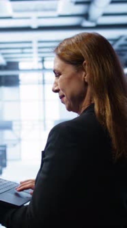 Vertical Video IT Specialist in Server Hub Facility Monitoring Server Infrastructure Using Device