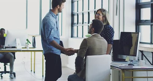 Businesspeople Shaking Hands in Modern Office