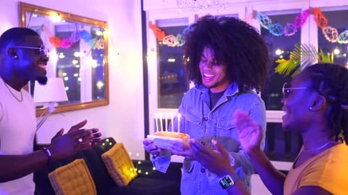 Friends Celebrate Birthday with Cake and Candles