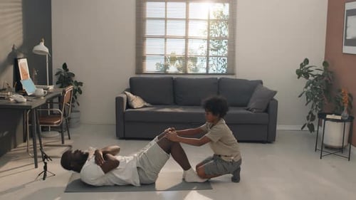 Father and Son Doing Physical Activity Indoors