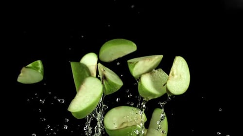 Radiant Fragments of Apple Emit Powerful Light Effects in Studio Environment Filmed on a Highspeed