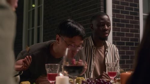 Friends Sharing a Meal at Night