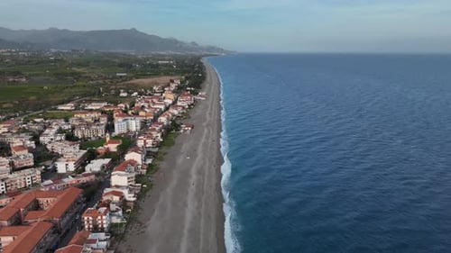 Aerial Coastal View of Tranquil Town and Serene Sea Horizon