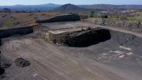 Aerial shot by a drone of a quarry blast. This is a controlled demolition to extract rock frame the